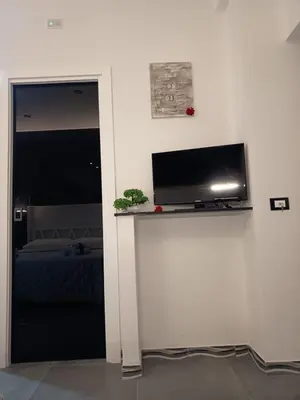 a room with a flat screen tv on a wall at La Suite del Viaggiatore in Palermo