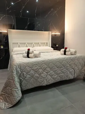 a bedroom with a large bed with pillows on it at La Suite del Viaggiatore in Palermo