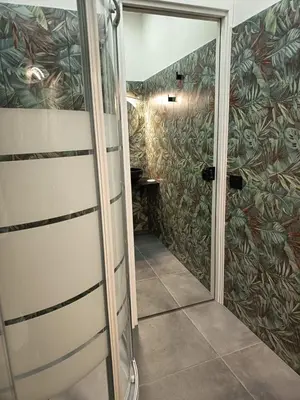 a bathroom with a shower and a glass door at La Suite del Viaggiatore in Palermo