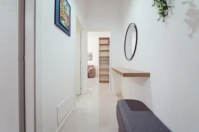 a hallway with white walls and a mirror on the wall at CastroViva House in Palermo