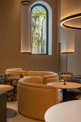 a waiting room with chairs and tables and a stained glass window at Palazzo Balsamo Boutique Hotel in Palermo