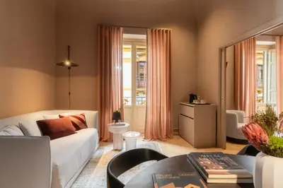 a living room with a couch and a table at Palazzo Balsamo Boutique Hotel in Palermo