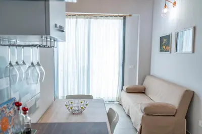 a living room with a couch and a table at Casetta Giardinetto in Altavilla Milicia