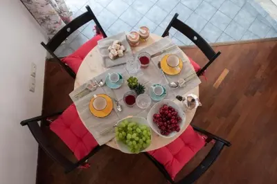 a table with plates of food and fruit on it at Casa Duci - Historic center in Palermo