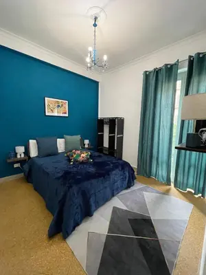 a blue bedroom with a bed with a blue wall at Casa Amuri in Palermo