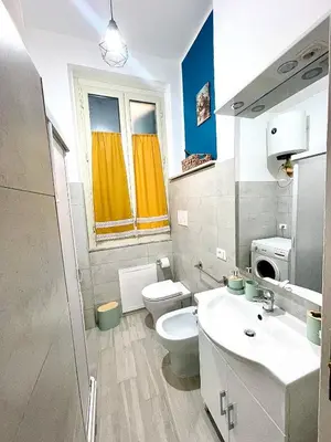 a bathroom with a toilet and a sink at Casa Amuri in Palermo