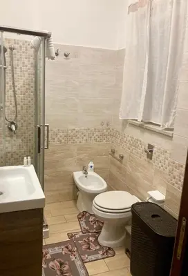 a bathroom with a toilet and a sink at Girasole Marino in Palermo