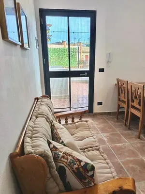 a room with a long couch in front of a window at Esperia Home in Palermo