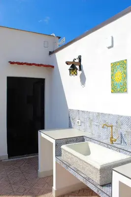 a bathroom with a sink on the side of a building at Esperia Home in Palermo