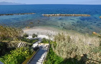 a small island in the water next to a beach at Cozy Apartment In Trappeto With Wifi in Trappeto