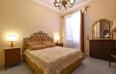 a bedroom with a large bed and a mirror at Cozy Apartment In Trappeto With Wifi in Trappeto