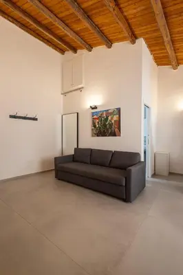 a living room with a couch in a white wall at Cathedral Apartment - Stay in Palermo in Palermo