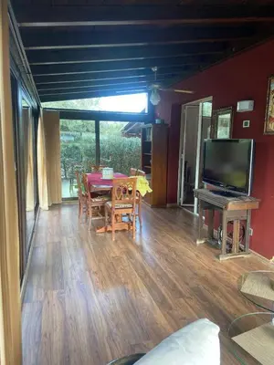 a living room with a table and a television at Il Giardino di Seba in Campofelice di Roccella
