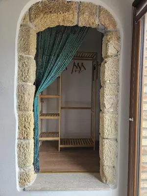 a doorway into a room with a blue curtain at Villa Cerasella - Rustic Sicilian Retreat with Private Pool & Sunset View in Trappeto