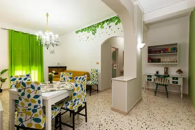 a kitchen and dining room with a table and chairs at Holiday Apartment My House in Palermo