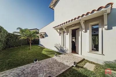 a white house with a walkway next to a yard at Esclusiva Villa con Piscina Privata a Mondello in Palermo