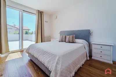 a bedroom with a bed and a large window at Esclusiva Villa con Piscina Privata a Mondello in Palermo