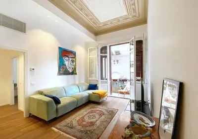 a living room with a couch and a window at Solemar Sicilia - Casa Castiglione in Palermo