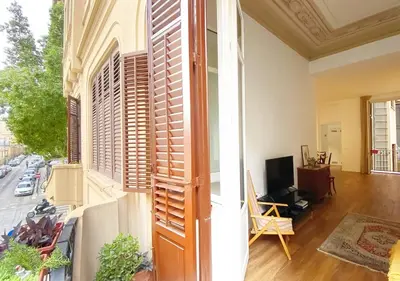 a bedroom with a bed with white sheets and purple pillows at Solemar Sicilia - Casa Castiglione in Palermo