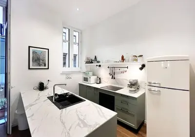 a kitchen and a dining room with a table and chairs at Solemar Sicilia - Casa Castiglione in Palermo