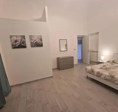 a bedroom with a bed and paintings on the wall at Palermo House 29-Central Station in Palermo