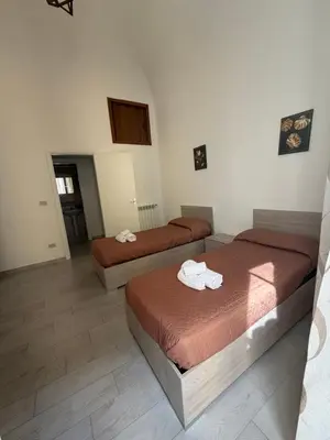 a room with two beds with towels on them at Palermo House 29-Central Station in Palermo
