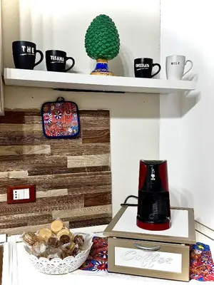 a coffee maker on a box on a shelf at Family house in Palermo