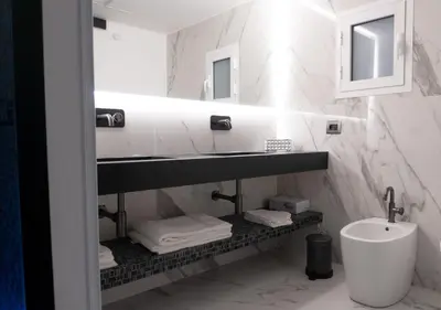a bathroom with a sink and a toilet and a mirror at Algaria Sicilian Suites in Palermo