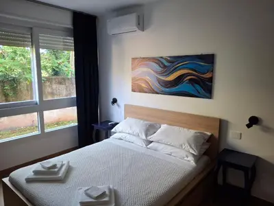 a bedroom with a bed and a painting on the wall at La Casa di Simo in Palermo