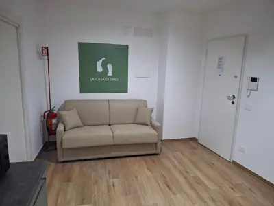 a living room with a couch in front of a door at La Casa di Simo in Palermo