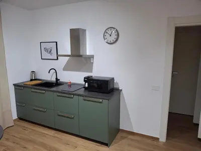 a kitchen with a sink and a clock on the wall at La Casa di Simo in Palermo