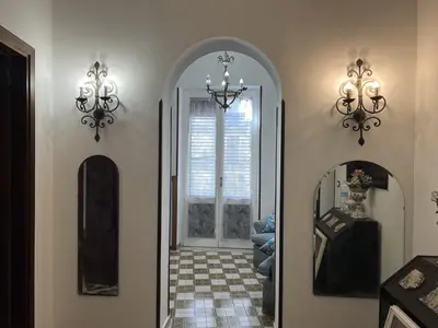 a hallway with two mirrors and a chandelier at Cluverio House Apartment in Palermo