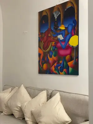 a painting on a wall above a couch with pillows at Casa Levante in Palermo