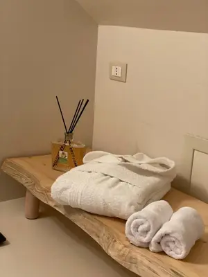 two towels are sitting on a wooden table at Casa Levante in Palermo