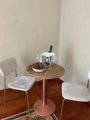 a table with a bowl of grapes and a bottle of wine at Casa Levante in Palermo