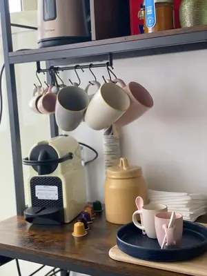 a shelf with cups and a toaster on a table at Casa Levante in Palermo