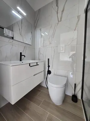 a white bathroom with a toilet and a sink at GiuAdel casa Palermo in Palermo