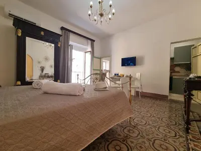 a bedroom with a bed with a pillow on it at Donna Emma by Holiday World in Carini