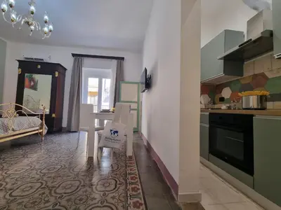 a kitchen with a table and a dining room at Donna Emma by Holiday World in Carini