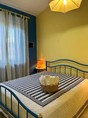 a bedroom with a bed with a basket on it at Casa Vacanza Pinto a 80 mt dal mare in Campofelice di Roccella