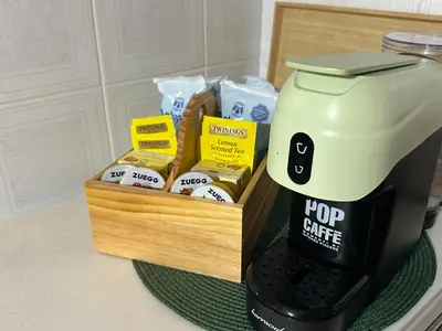 a coffee maker sitting next to a box of food at Casa Vacanza Pinto a 80 mt dal mare in Campofelice di Roccella