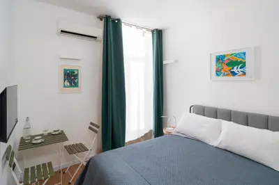 a bedroom with a bed and a window at ControCanto Elegant Stay - 3 bedroom flat in Palermo