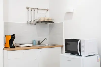 a kitchen with a microwave and a sink at ControCanto Elegant Stay - 3 bedroom flat in Palermo