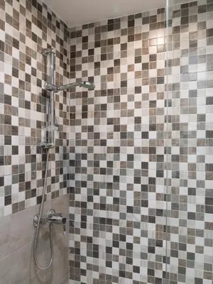 a bathroom with a shower with a tiled wall at ControCanto Elegant Stay - 3 bedroom flat in Palermo
