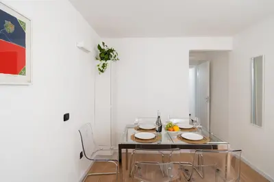 a dining room with a table and two chairs at ControCanto Elegant Stay - 3 bedroom flat in Palermo