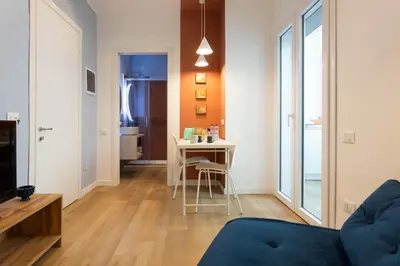 a living room with a table and chairs in a room at Don Federico - For Couple in Palermo