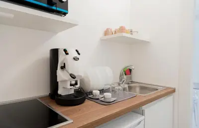 a kitchen with a coffee maker on a counter next to a sink at Cielo D'Alcamo Palazzo Oliva in Alcamo