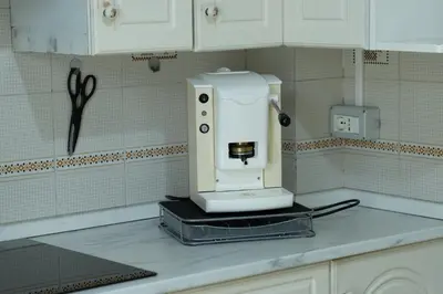 a white coffee maker on a counter in a kitchen at Ampio Appartamento con 3 Camere vicino la stazione - Re D'Aragona Vacanze in Termini Imerese