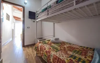 a bedroom with a bed and a bunk bed at Amazing Home In San Cipirello With Swimming Pool in San Cipirello