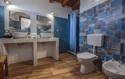 a bathroom with a toilet and a sink and mirrors at Amazing Home In San Cipirello With Swimming Pool in San Cipirello